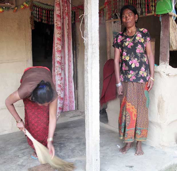 Sita Kumal sweeps the front porch of their house as Ramkumari Kumal, her mother-in-law, looks on Photo: ICIMOD